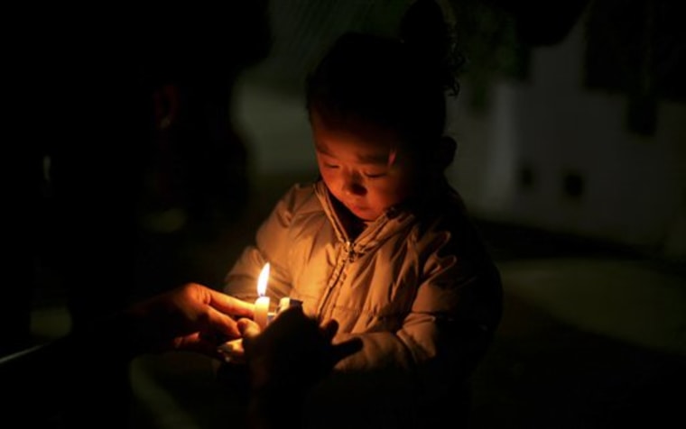 A young Tibetan girl participates in a candlelit vigil for Tibetans who self-immolated in Tibet, in Bodh Gaya, Bihar state, India, on Sunday, Jan. 8. Bodh Gaya is believed to be the place where Buddha attained enlightenment. 